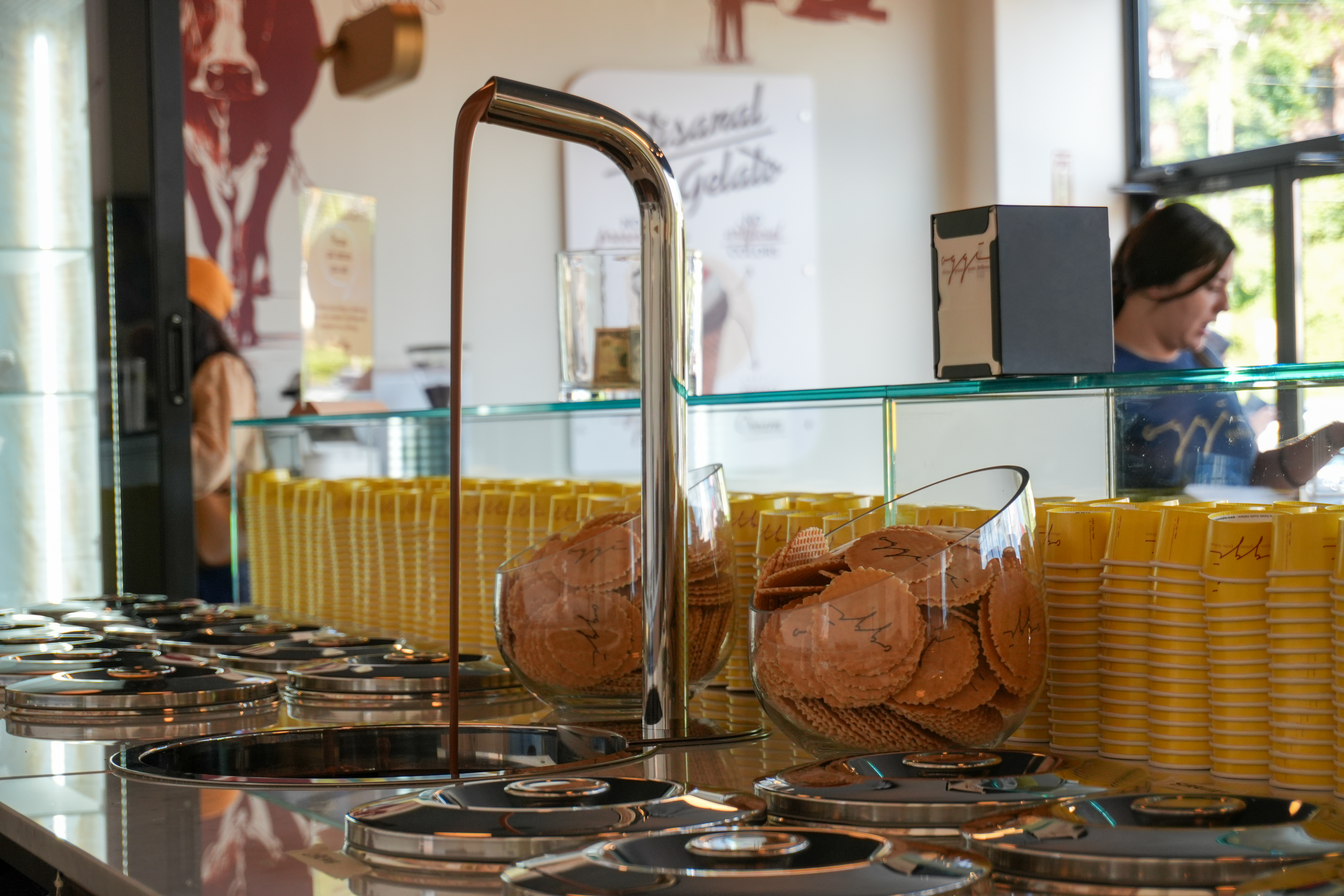 Oggi Gelato counter with cones and yellow cups